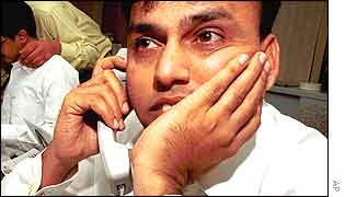 Pakistani stock broker on the phone
