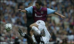 Scott Minto of West Ham is tackled by Shaun Wright-Phillips of Manchester City 