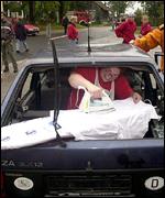 A competitor irons from the back of a car