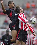 Charlton's Jon Fortune (left) barges into Southampton forward Jo Tessem