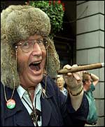 Racing pundit John McCrirrick enjoys a cigar