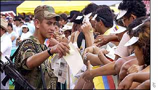 A soldier hands out leaflets on security
