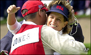 Rosie Jones of the US team gets a hug from her caddie