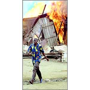 A foreigner running away from a burning shack [picture: AP]