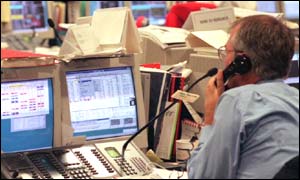 Trader watches the screen at his desk 