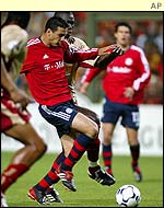 Bayern Munich's Claudio Pizarro is tackled by Lens' Papa Diop Bouba