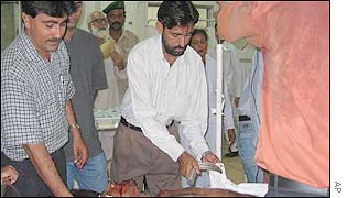 Medical personnel at a Karachi hospital attend to one of the wounded men evacuated after the attack