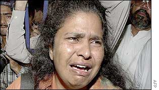 Relative of one of the men killed grieves outside the charity headquarters