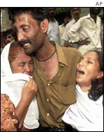 A family grieves after the attack in Karachi