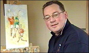 Armagh artist Seamus Duffy and the painting that the BBC is offering for a prize