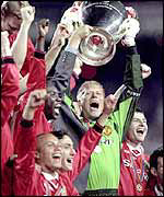Manchester United raise the Champions League trophy in 1999
