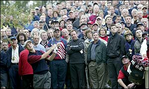 Toms plays at the sixth under the watchful eyes of a packed gallery