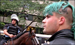 Protester facing a line of mounted police