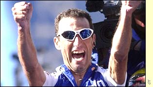 Jose Garcia Acosta raises his arms to celebrate winning the 19th stage