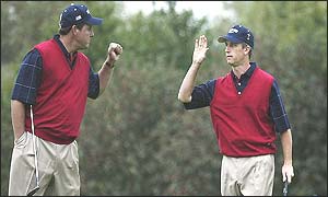 Phil Mickelson and David Toms celebrate winning a hole
