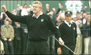 Colin Montgomerie shows his joy at putting Europe into a one point lead after he holes a putt on the 18th