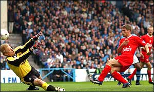 Peter Schmeichel in familiar pose, but Michael Owen breaks his goal drought