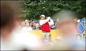 Tiger Woods tees off at the eighth hole as the tension mounts in a close battle against Sergio Garcia and Lee Westwood