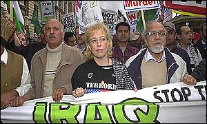 Protesters wave banners and shout out their opposition