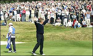 Colin Montgomerie raises his arms and acknowledges the crowd after sealing Europe's first win of the day, beating Scott Hoch 4&3 to put Europe 9-8 up
