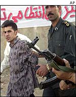 Amir Karbalai (l) being led to execution in September 2001