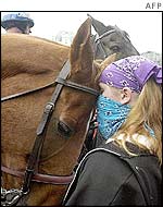 A protester bonds makes friends with a police horse