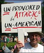 Protester holding sign decrying use of first strike