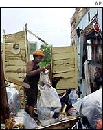 Woman in Barbados surveys the wreckage of her home following tropical storm Lili