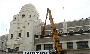 A digger rmoves a wall at Wembley Stadium