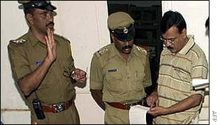 Police inspect the bodies of five Muslim militants 