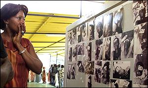 A Senegalese woman looks at photos of the dead