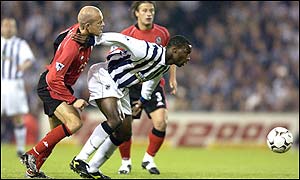 Balackburn defender Henning Berg pursues West Brom striker Jason Roberts