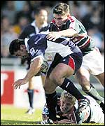Daryl Gibson is tackled by Leicester's Steve Booth and Lewis Moody during Bristol's 25-20 win over the Tigers
