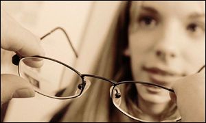 Girl tries on glasses