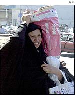 Woman with bag of food in Baghdad