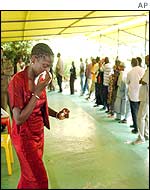 A relative weeps after viewing photos of the dead