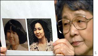 Sakie Yokota holds photos of her daughter Megumi