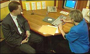 a client and a financial adviser sitting at a desk