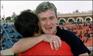 Wales defender Chris Coleman and manager Mark Hughes celebrate beating Belarus in Hughes' first game in charge
