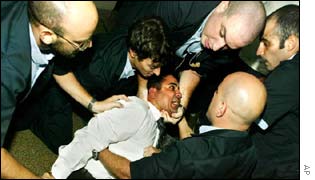 Israeli security officers subdue an Israeli Arab man outside the courtroom