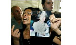 Israeli woman Brigitte Kessler with a picture of her 19-year-old daughter Gila, who was killed last June in a Palestinian suicide bombing 