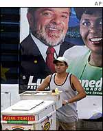 Ice-seller passes poster of Lula in Rio de Janeiro