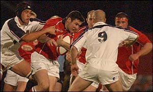 Llanelli fly-half Stehen Jones looks for a break in the Swansea defence