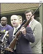 Joe Riehl of ATF holds a Remington rifle, possibly similar to that used in the attacks
