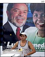 Man walking past a Lula election poster