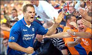 Ronald de Boer celebrates with Rangers fans after scoring against Celtic