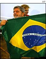 Lula carries a Brazilian flag 