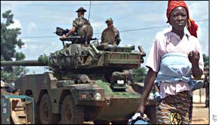 A woman walks past the French position in Tiebissou