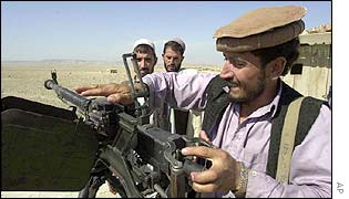Militiamen loyal to an Afghan warlord prepare their guns
