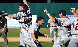 AJ Pierzynski (left), Eddie Guardado (centre) and Michael Cuddyer celebrate